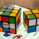 The Rubik’s Connected Cube looks and feels like the original (here it’s sitting next to a simpler 2x2 version of the puzzle) but features curved corners to facilitate Speedcubing.